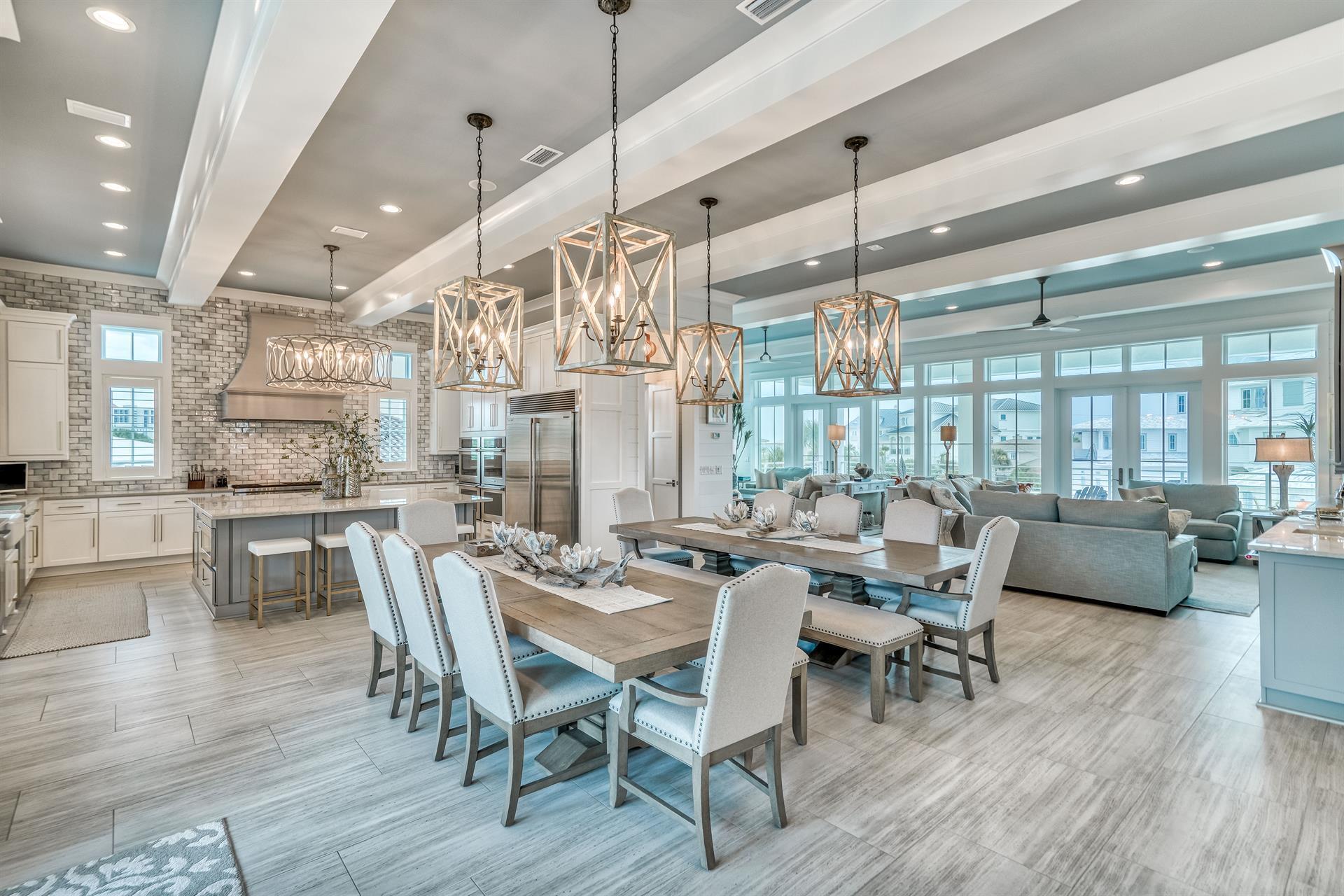 a dining room with wooden floor a chandelier a wooden table and chairs