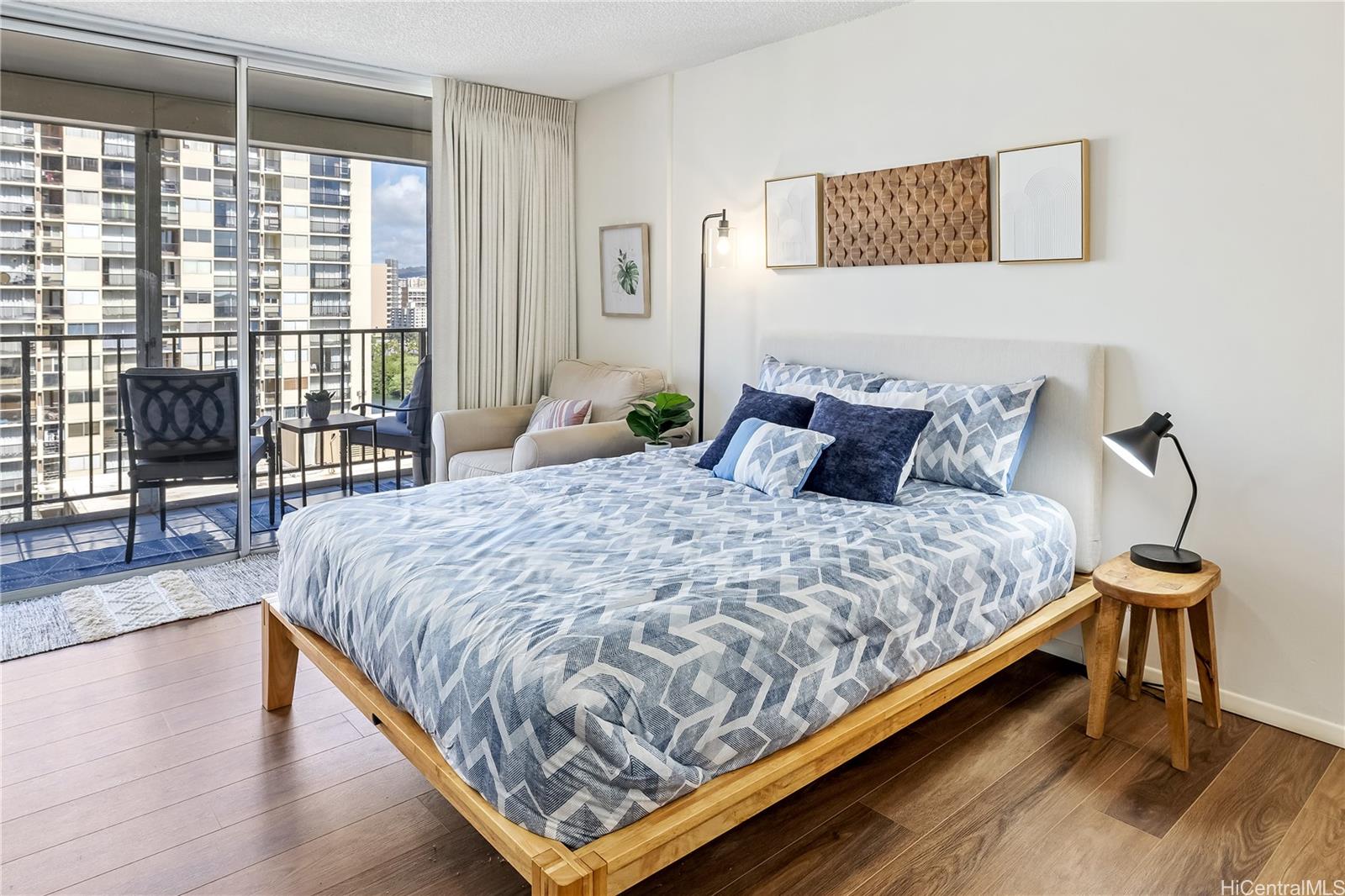 a bedroom with a bed and wooden floor