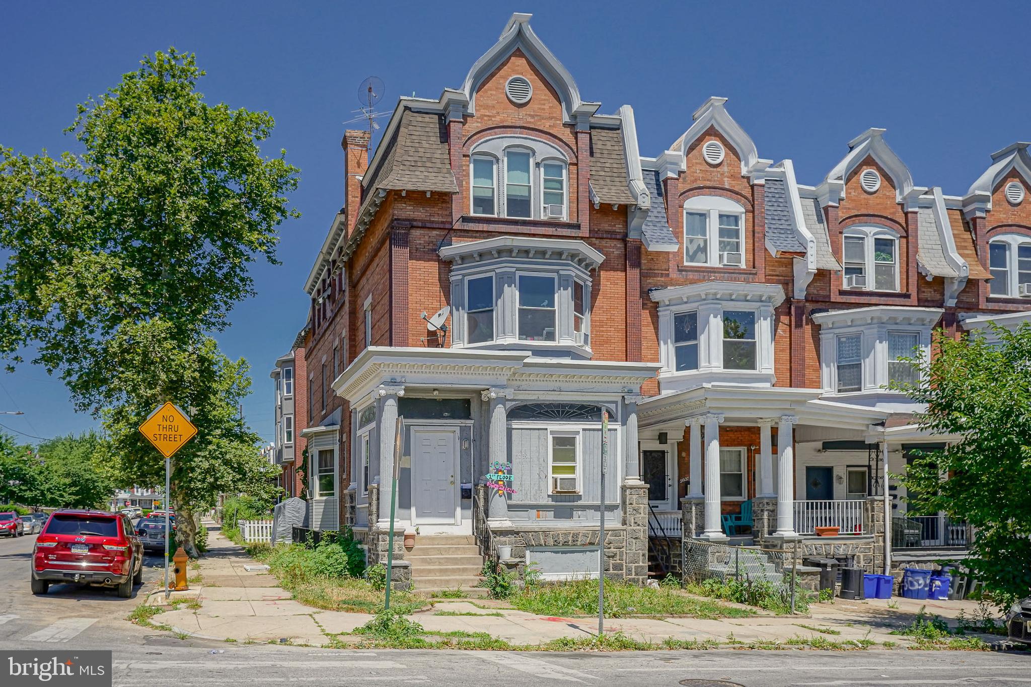 a view of a big house with many windows and a yard