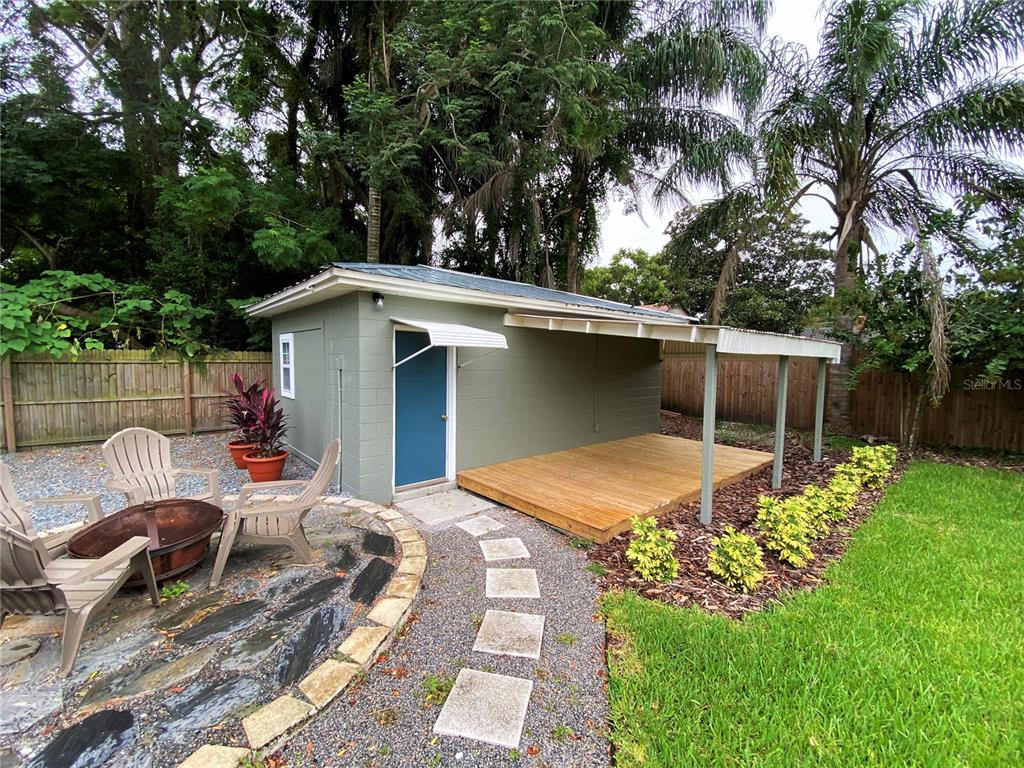 a view of backyard with outdoor seating and green space