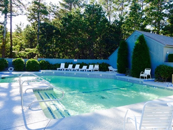 a view of backyard with swimming pool and patio