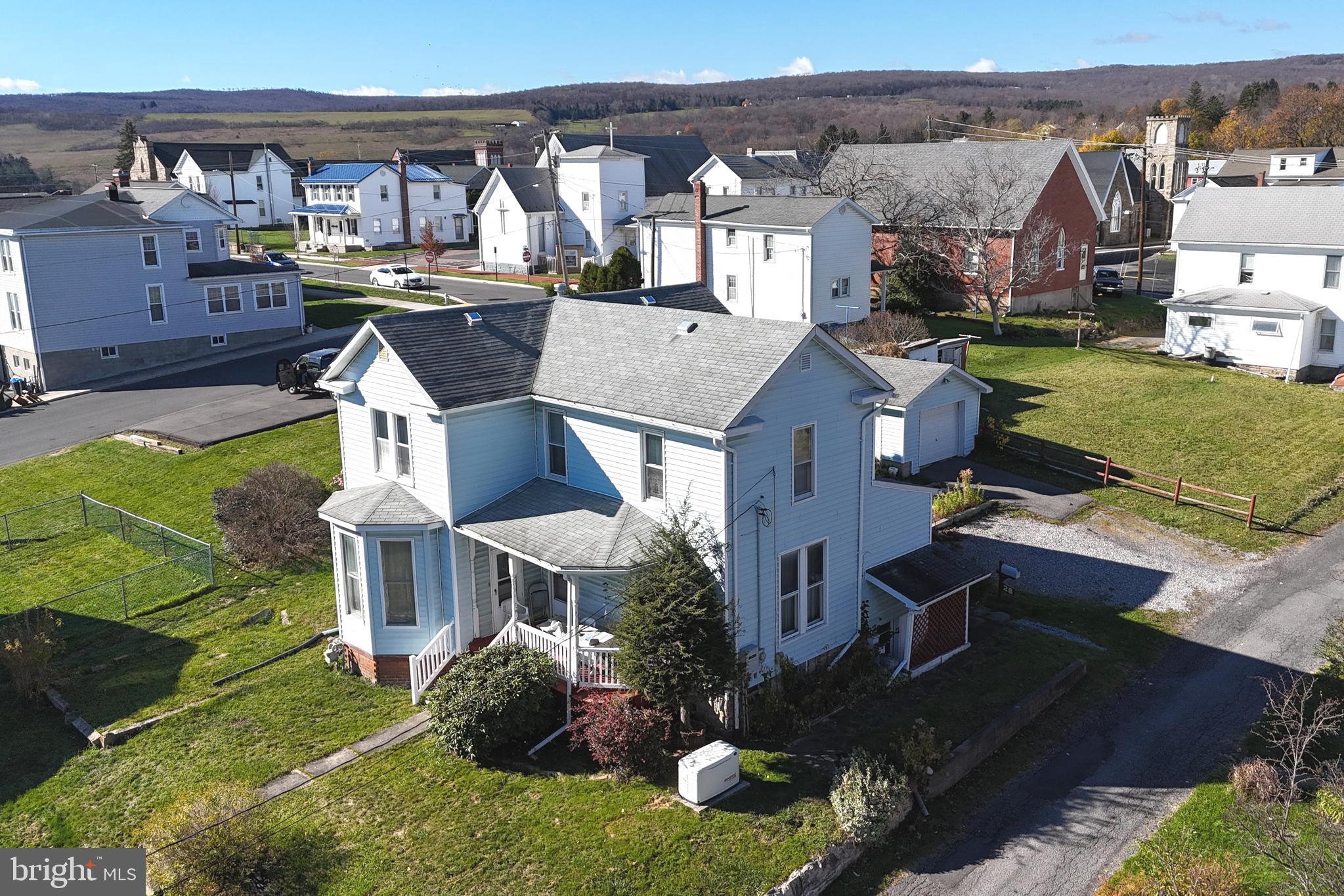 an aerial view of a house with swimming pool garden and balcony