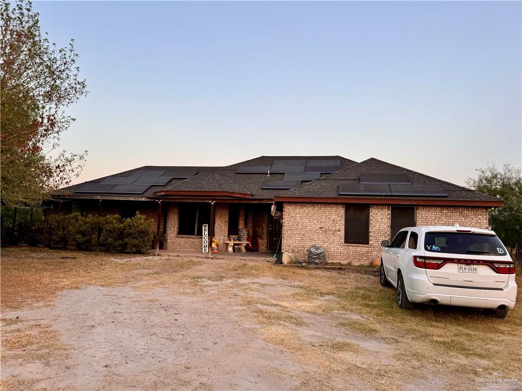 a front view of a house with cars parked