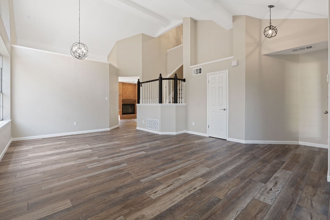 a view of a room with wooden floor and staircase