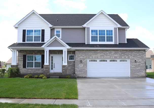 a front view of a house with a yard and garage