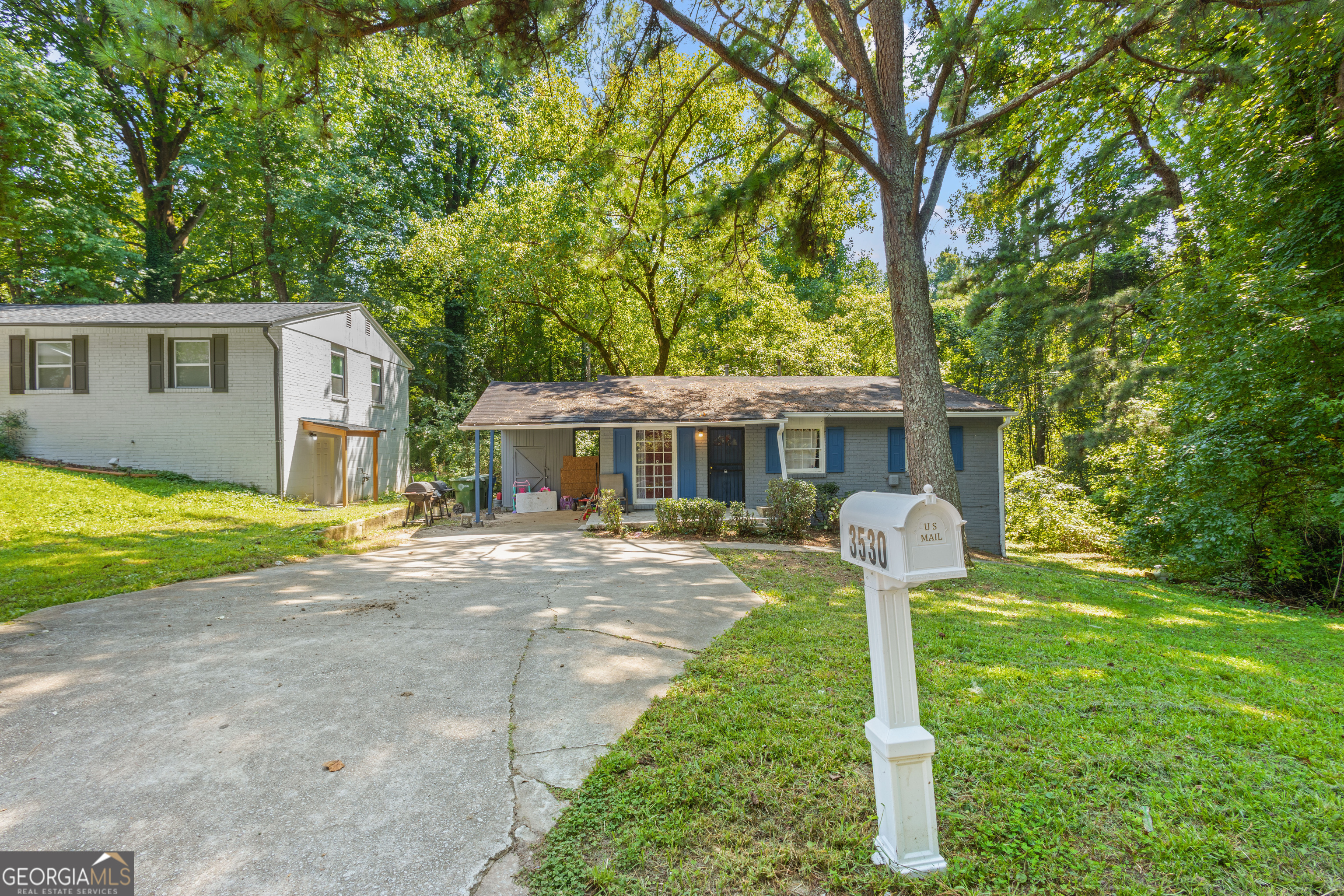 a front view of house with yard and green space