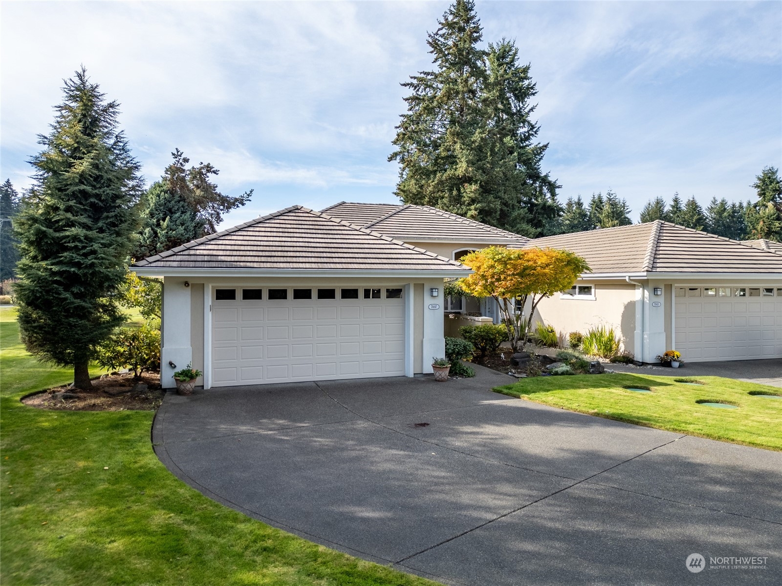 a view of a house with a yard and garage