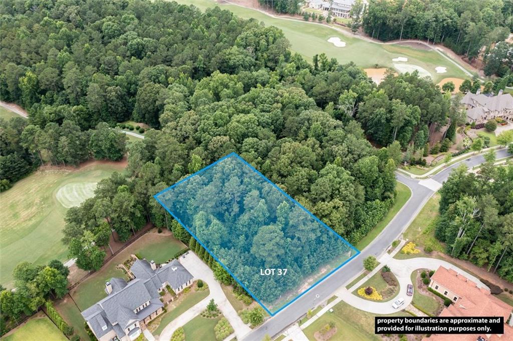 an aerial view of a residential houses with yard and greenery