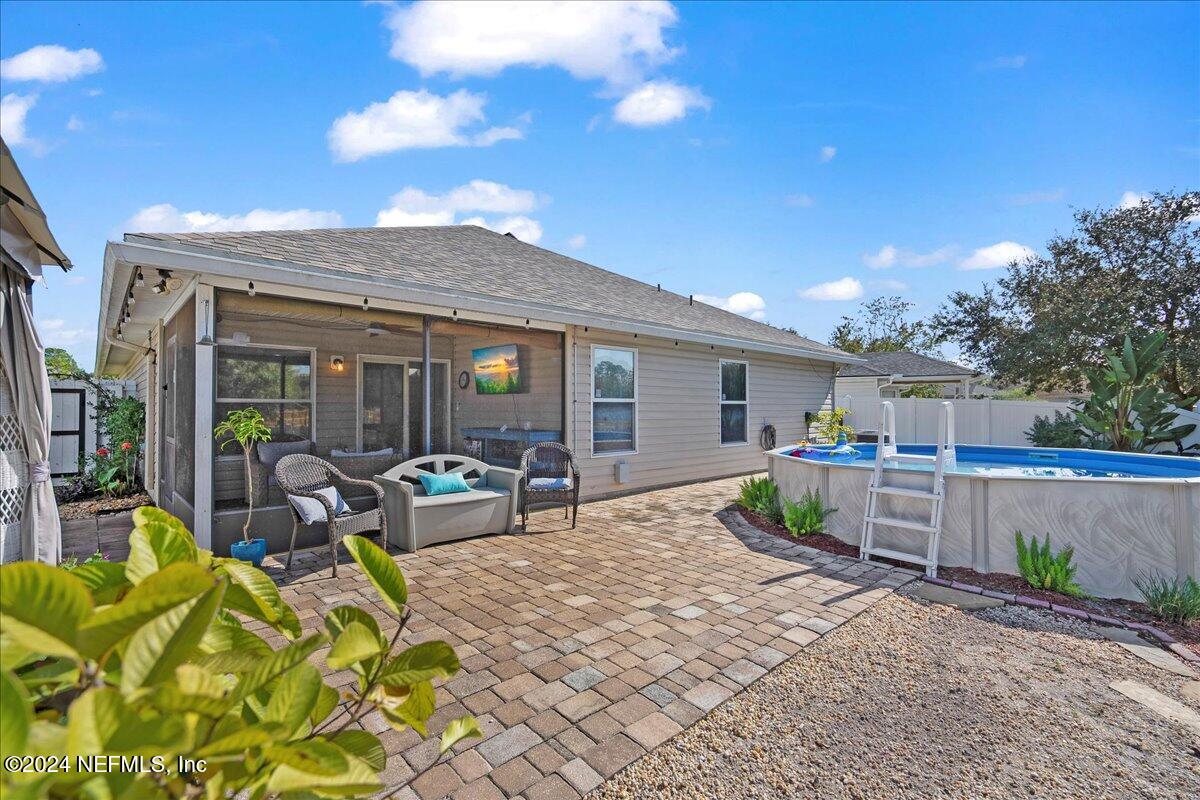 a view of house with backyard and sitting area