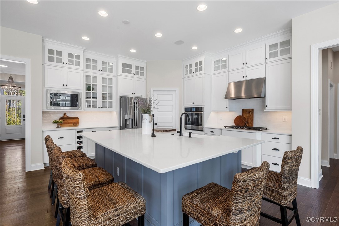 a large kitchen with a table chairs and a refrigerator