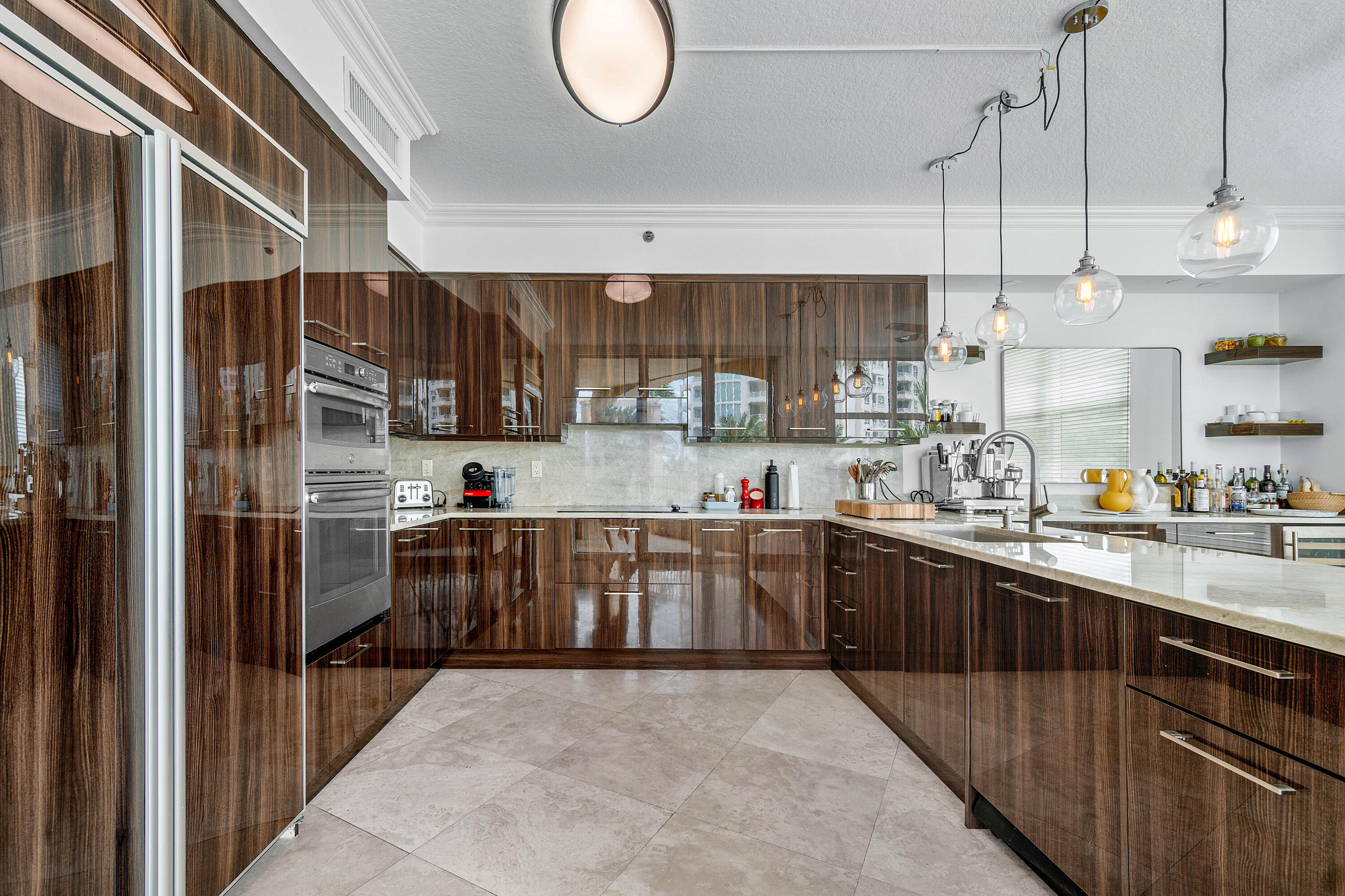 a kitchen with stainless steel appliances granite countertop a sink a stove and a refrigerator