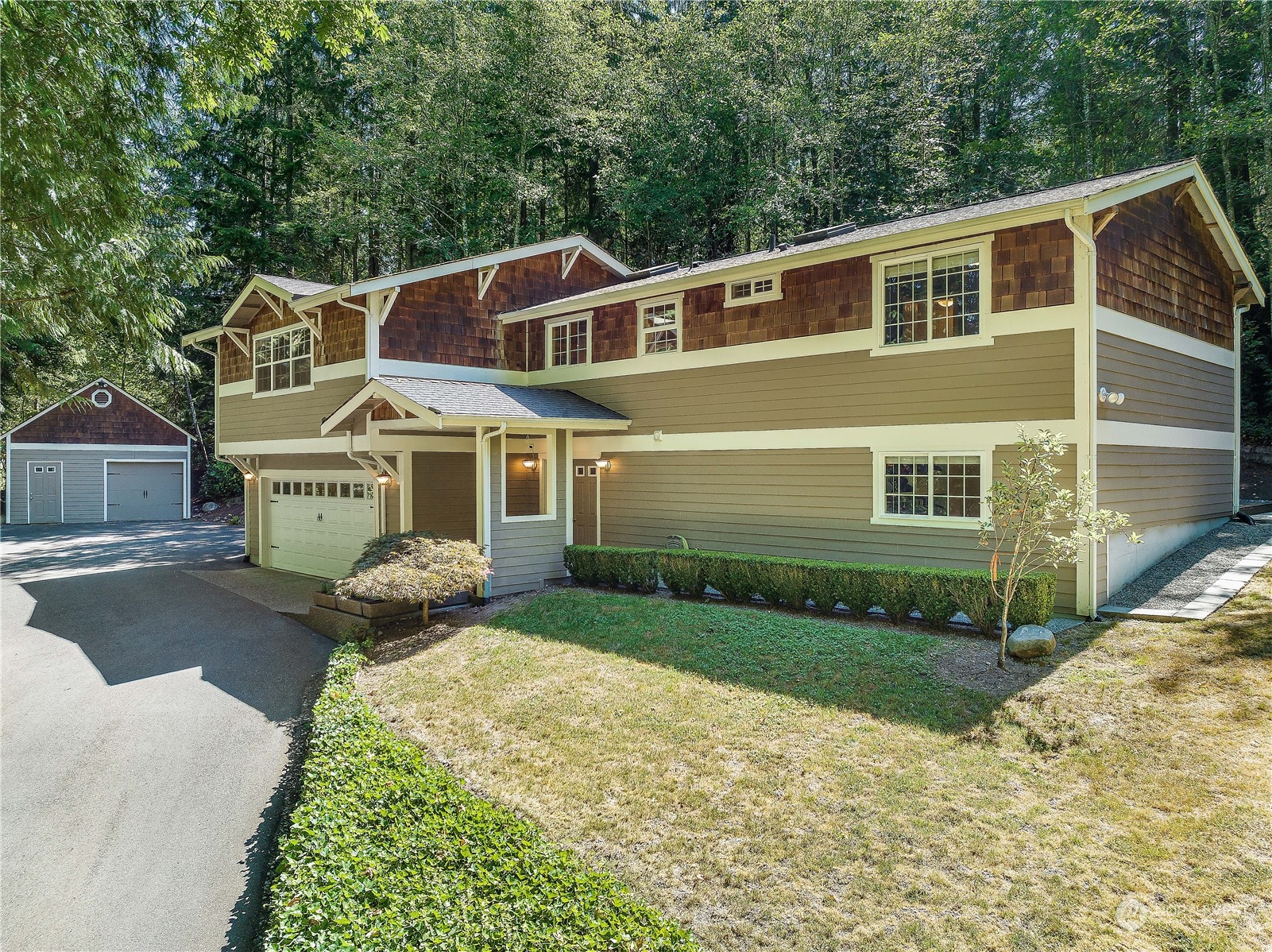 a front view of a house with a yard and garage