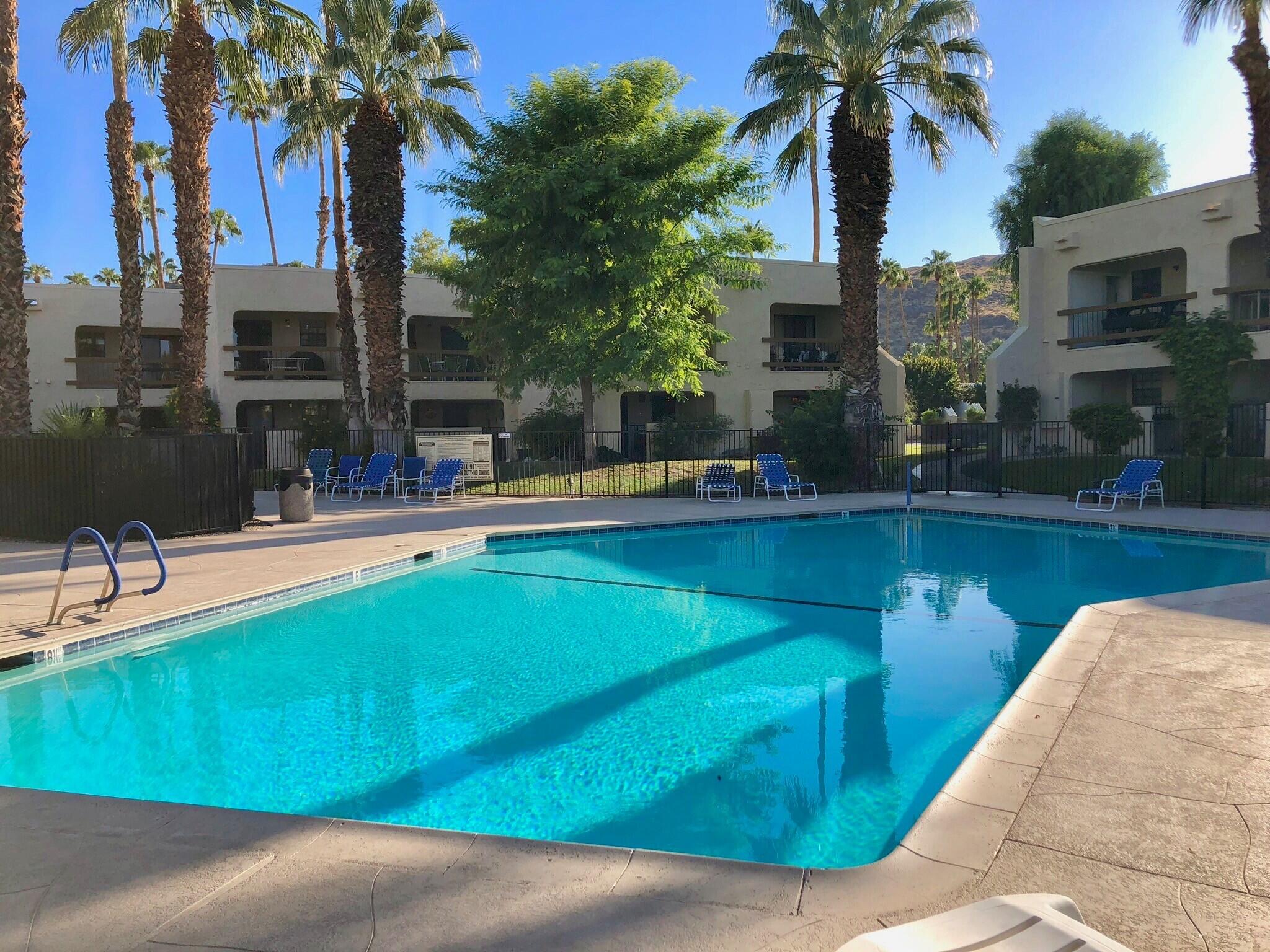 a view of a swimming pool with a table and chairs