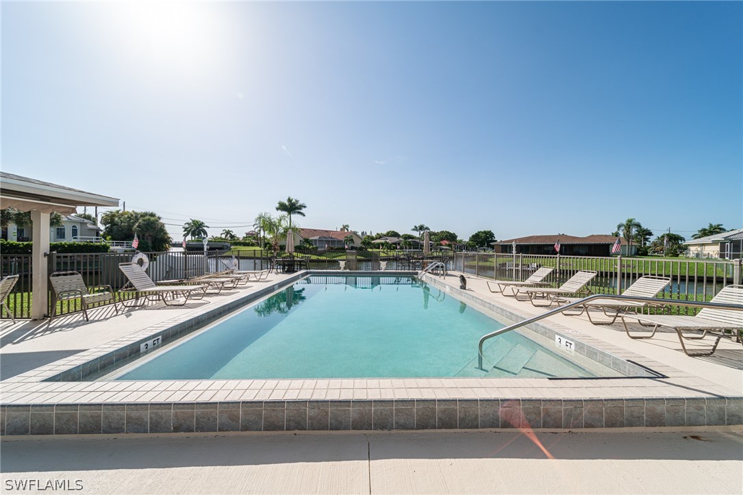 a view of a swimming pool with a lawn chairs