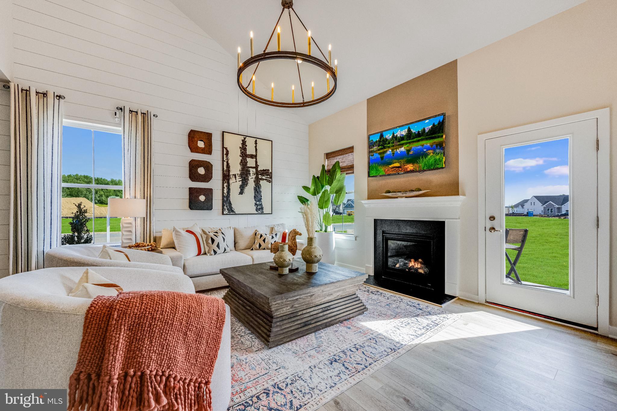 a living room with furniture a fireplace and a large window