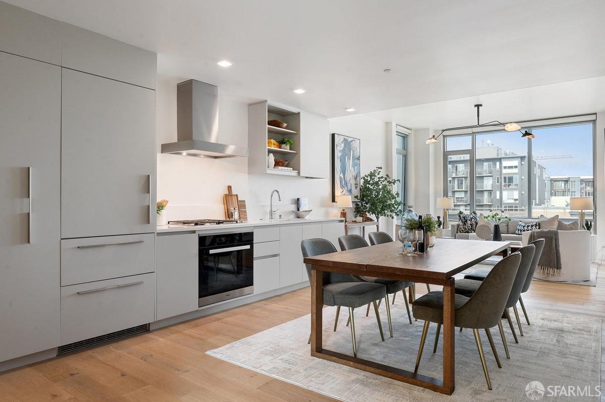 a kitchen with granite countertop white cabinets and stainless steel appliances