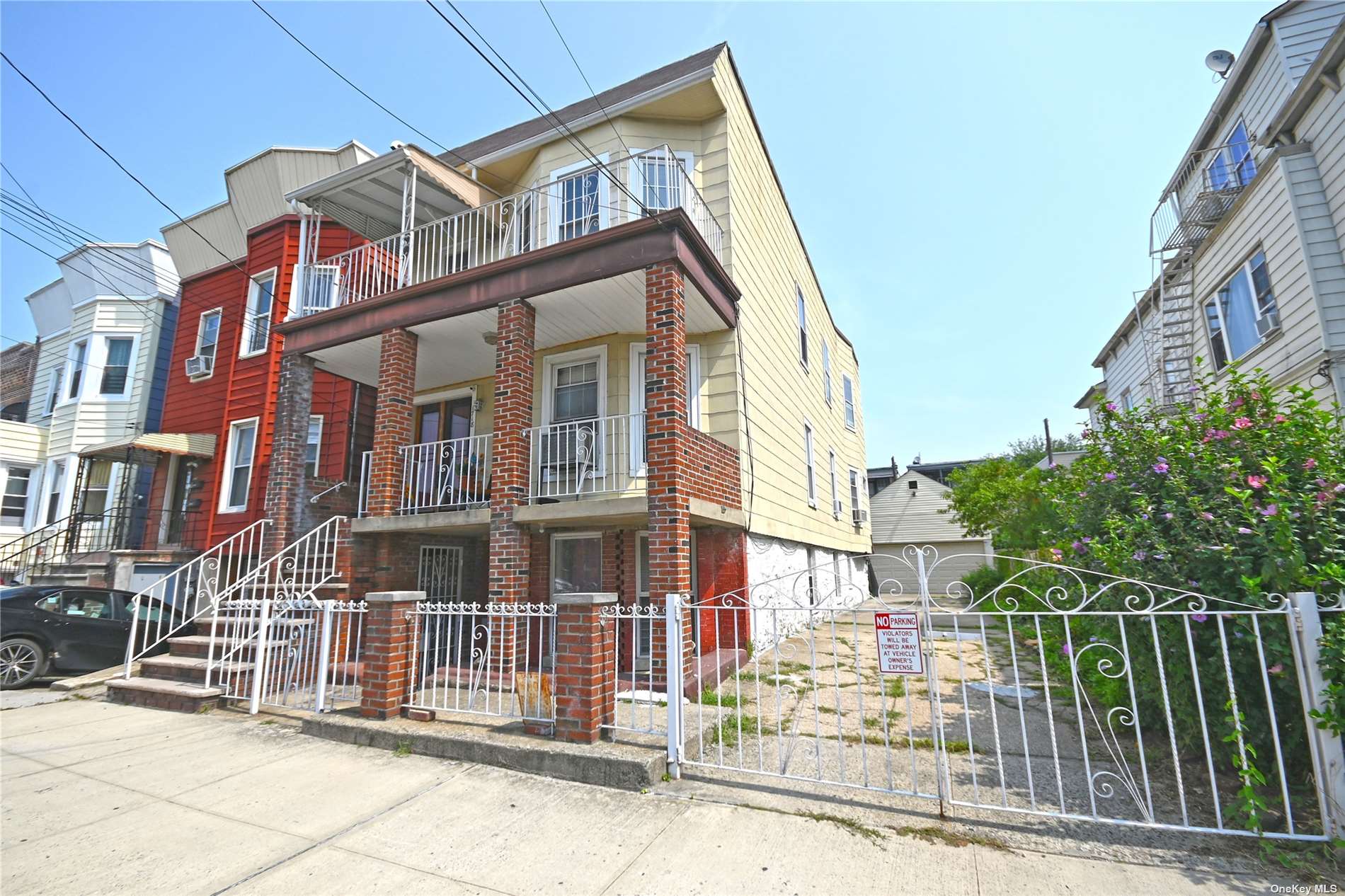 a front view of a multi story residential apartment building with glass door