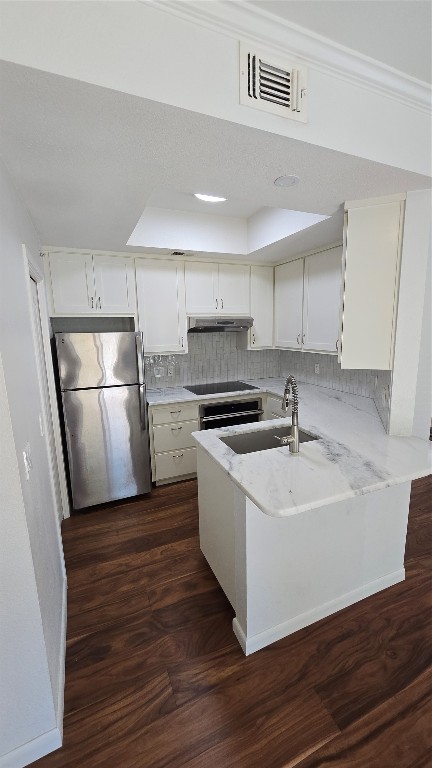 a kitchen with a sink stainless steel appliances a refrigerator and a sink