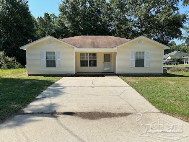 a front view of house with yard and trees