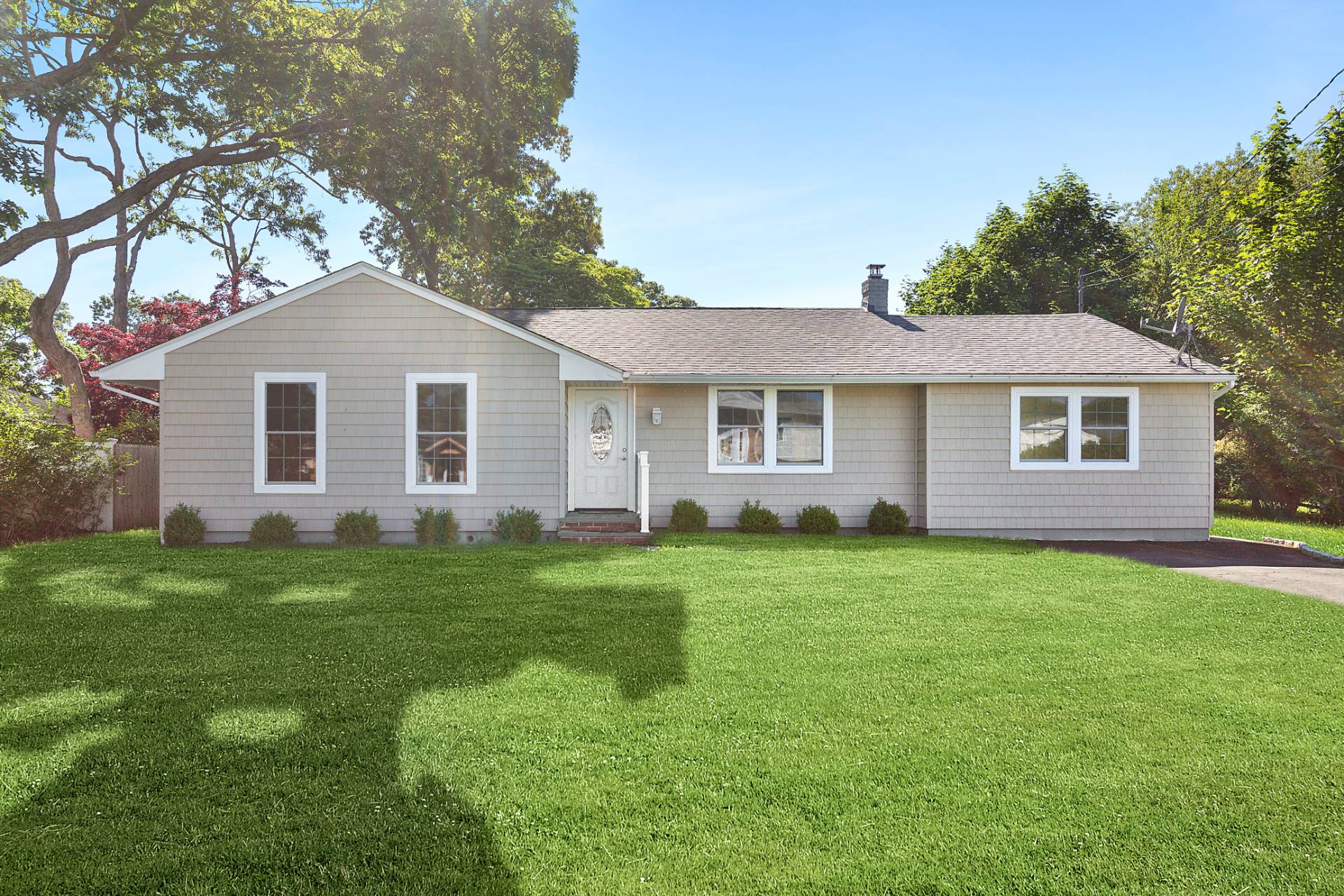 a front view of a house with a garden