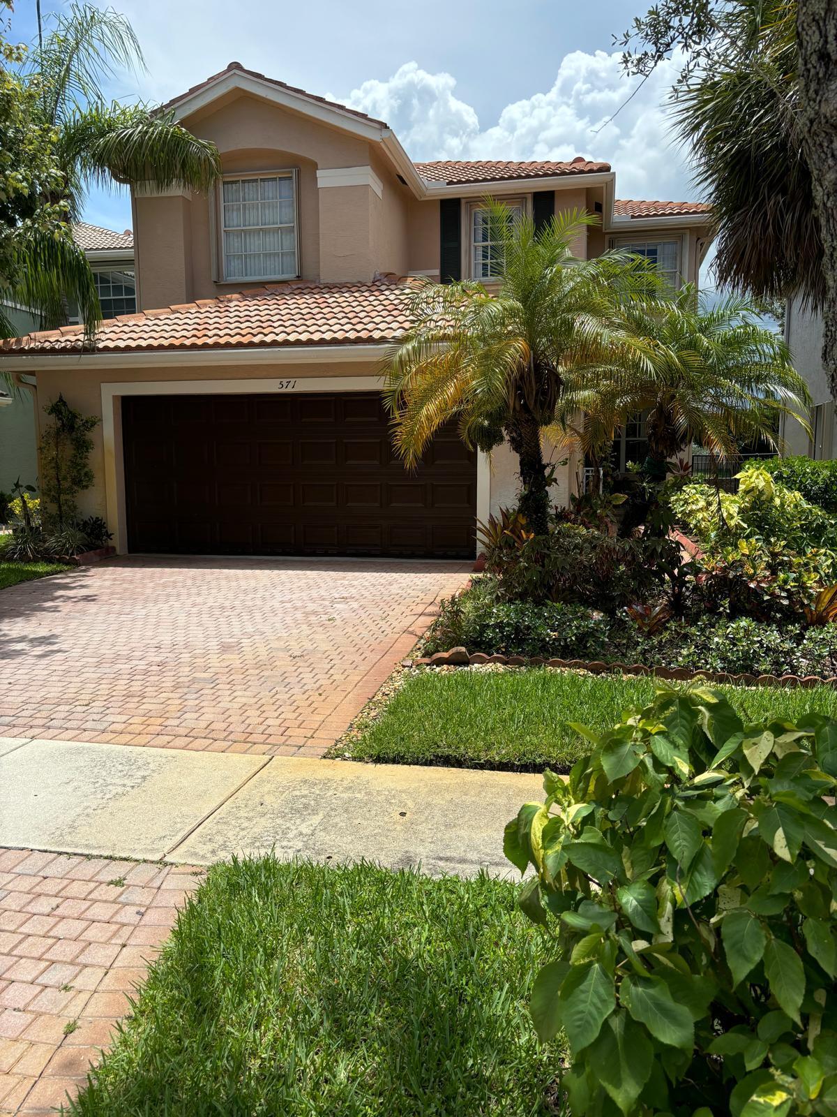 a front view of a house with a garden