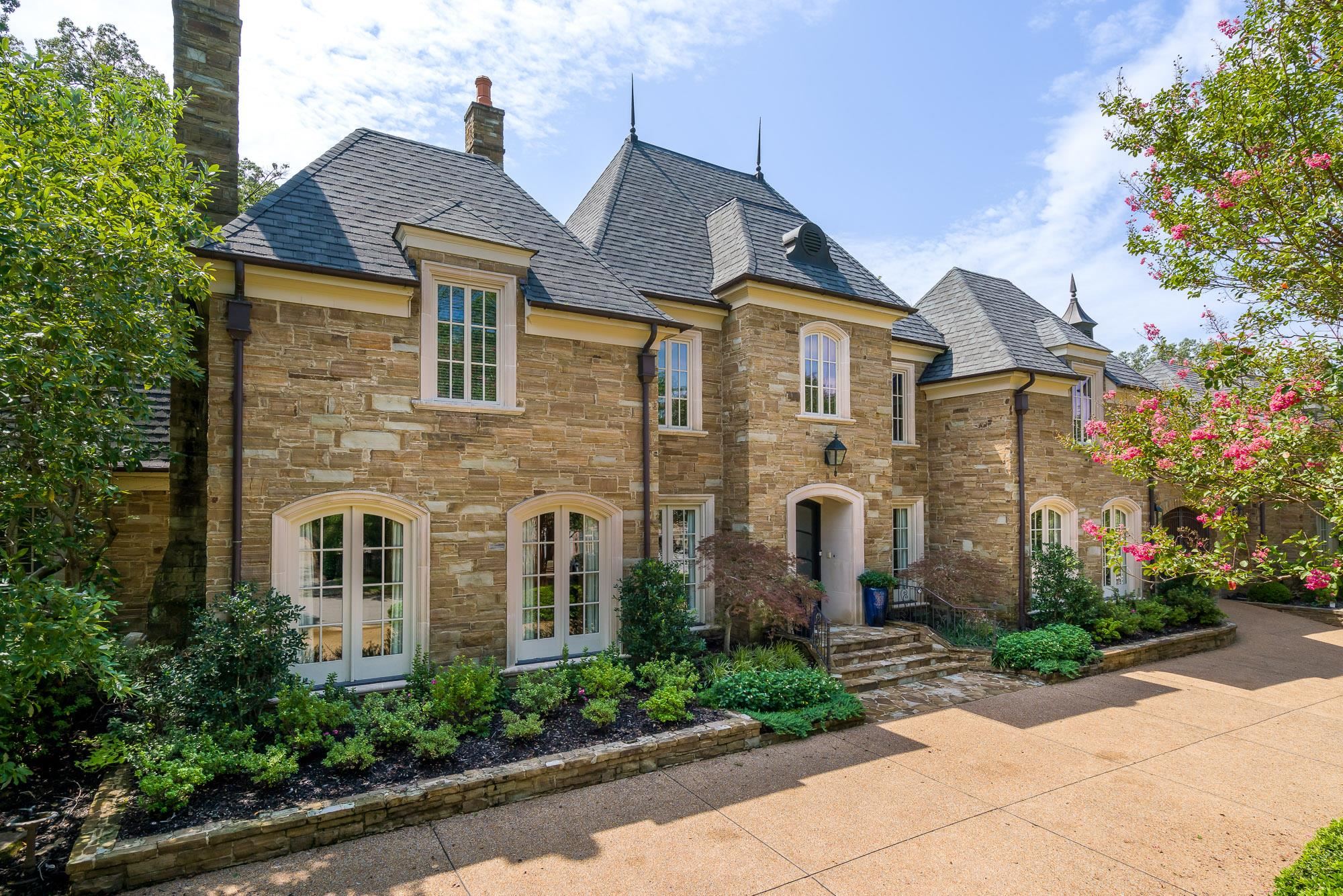 a front view of a house with garden