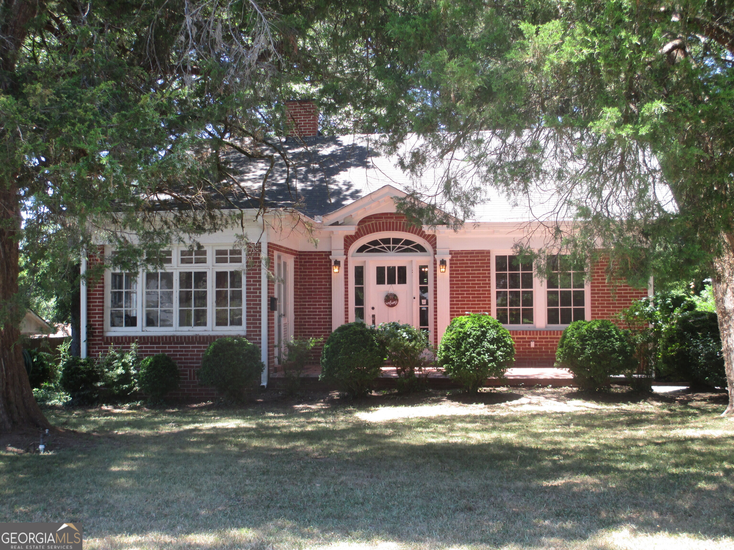 a front view of a house with garden