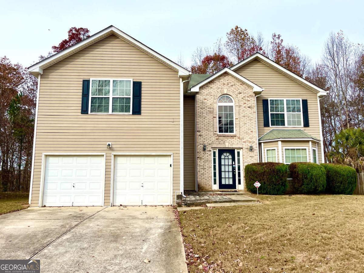 a front view of a house with a yard