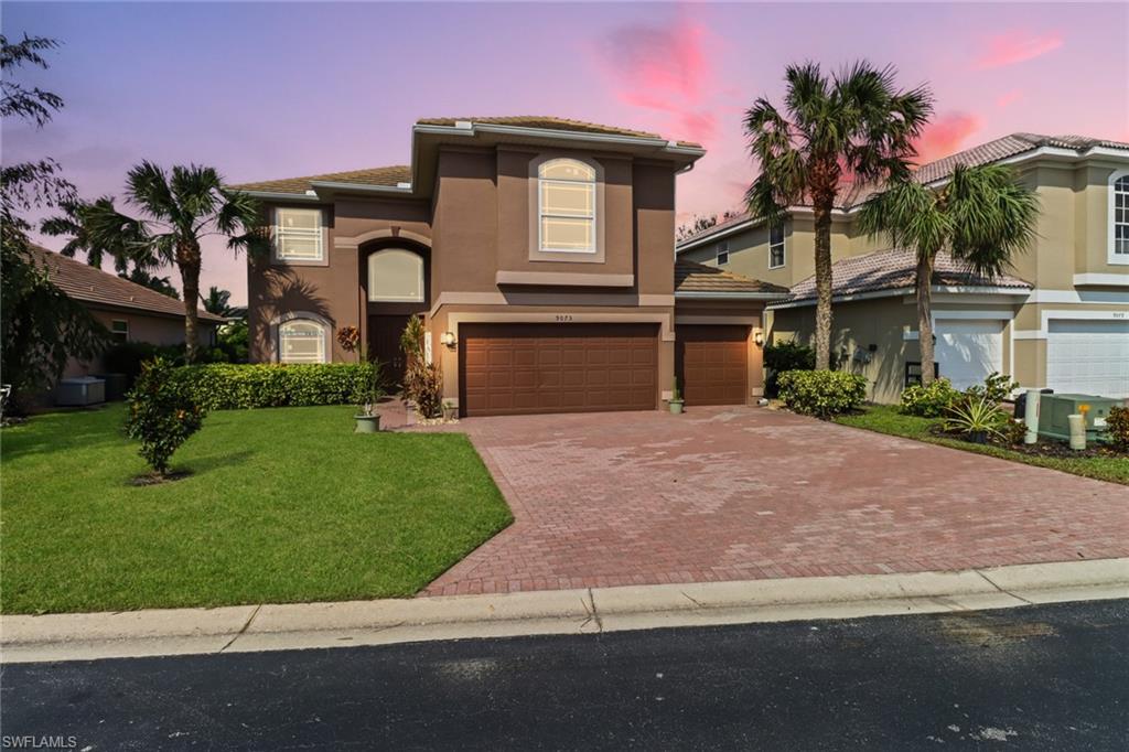 a front view of a house with a garden and a yard