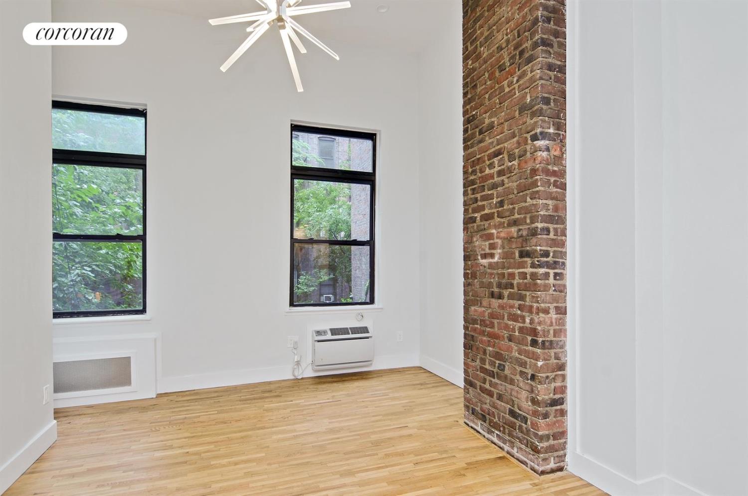 an empty room with windows and closet