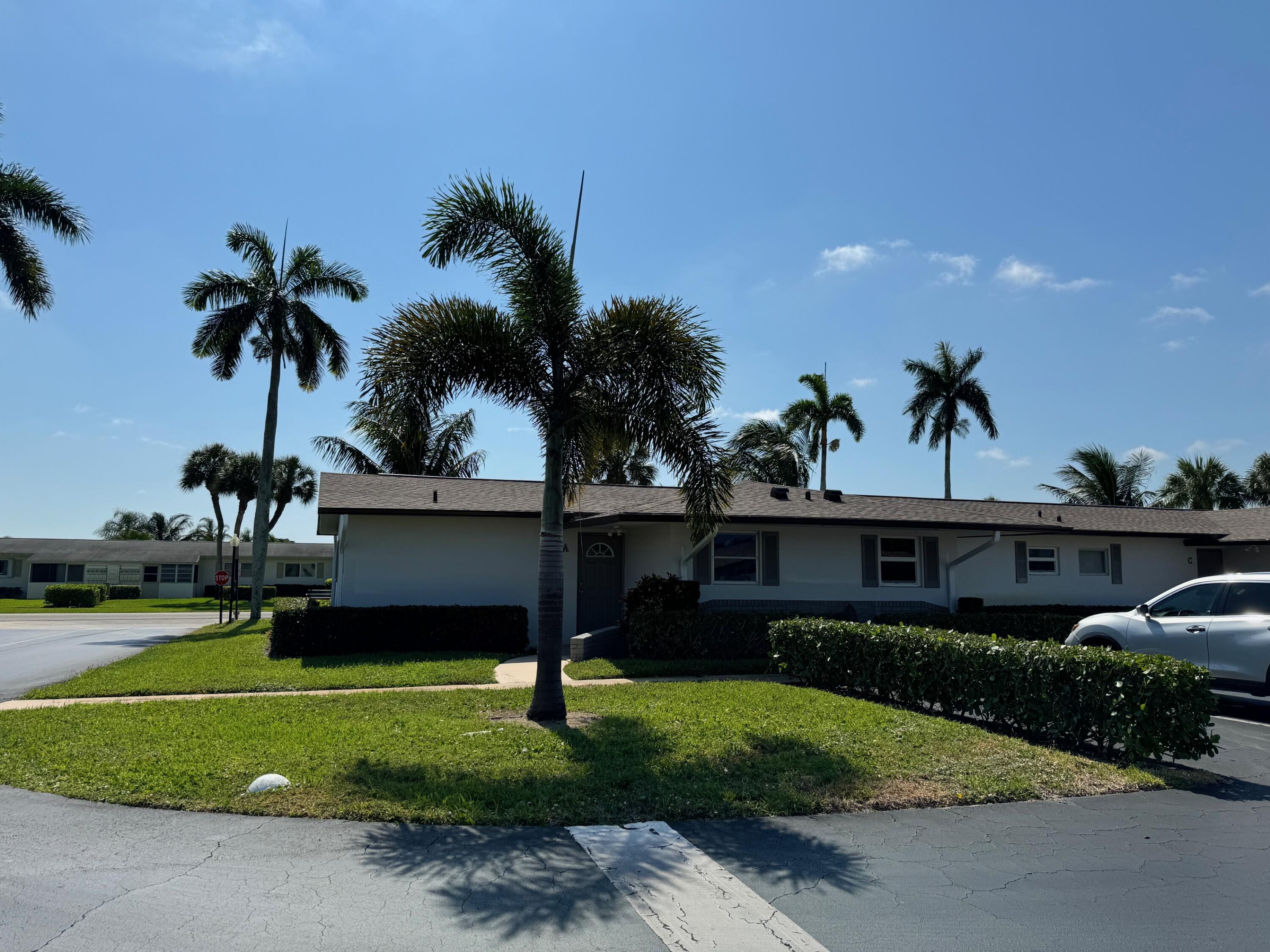 a front view of a house with a garden and yard