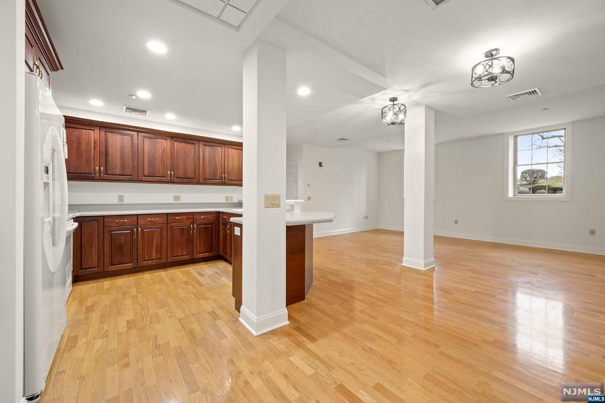 a view of kitchen with cabinets and wooden floor