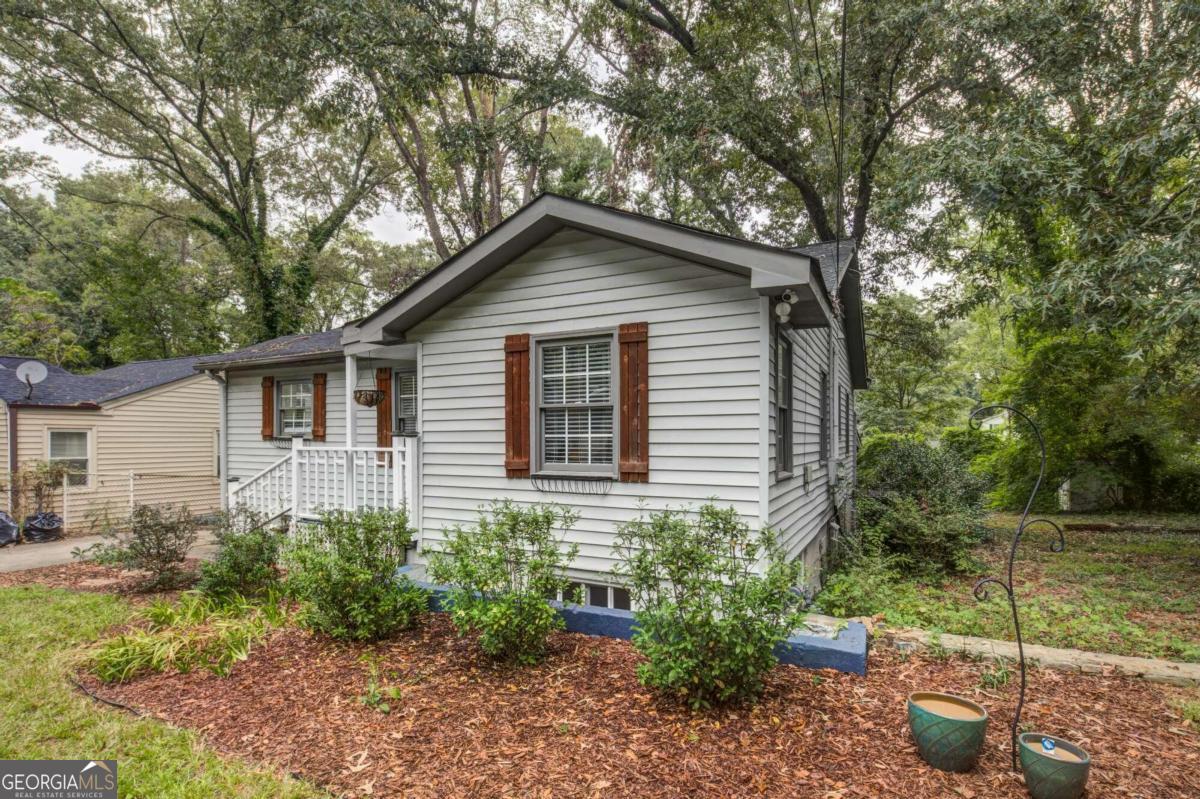 a house that has a tree in front of the house