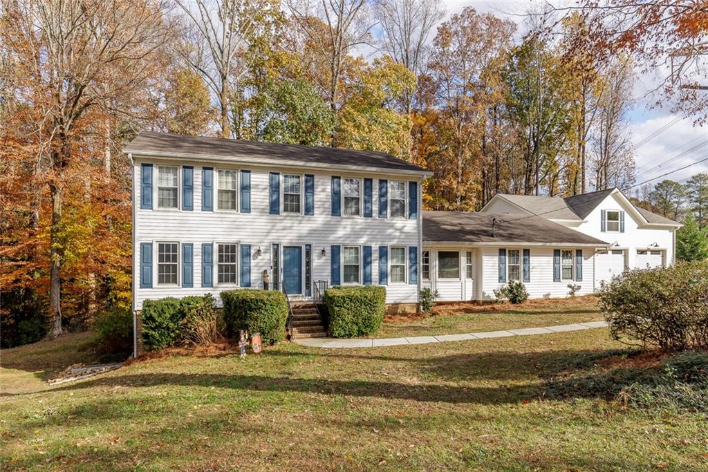 a front view of a house with a garden