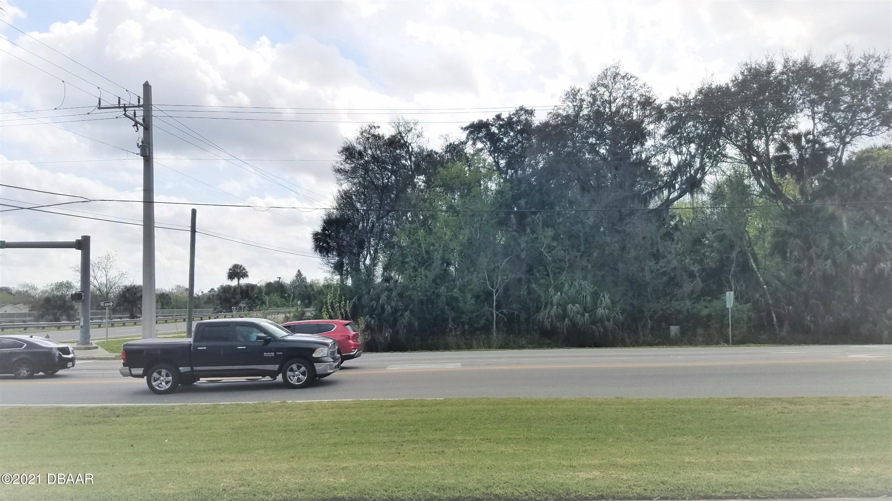 a view of a lake with a car parked on the side of the road