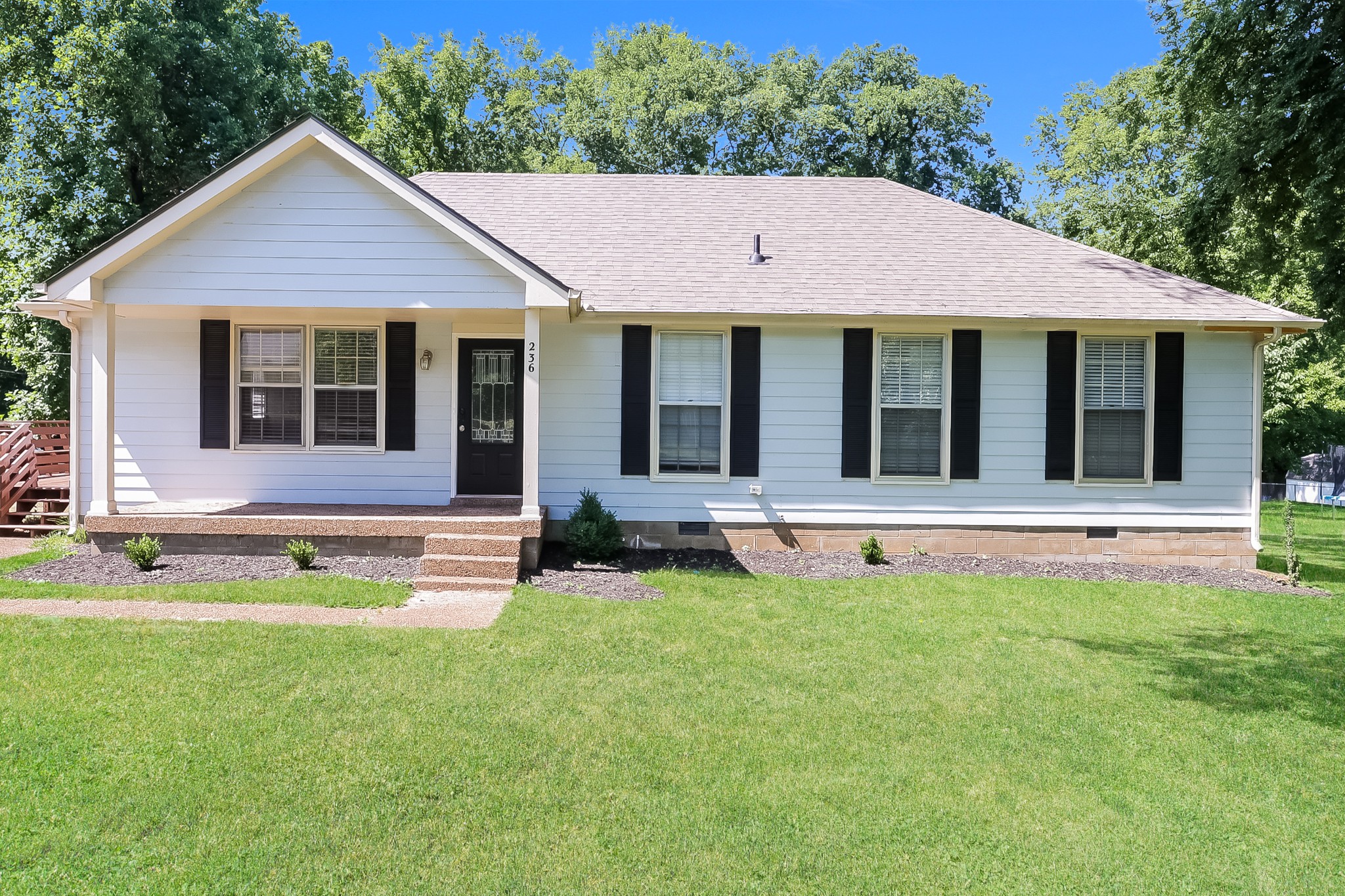 a view of a house with a yard and sitting area