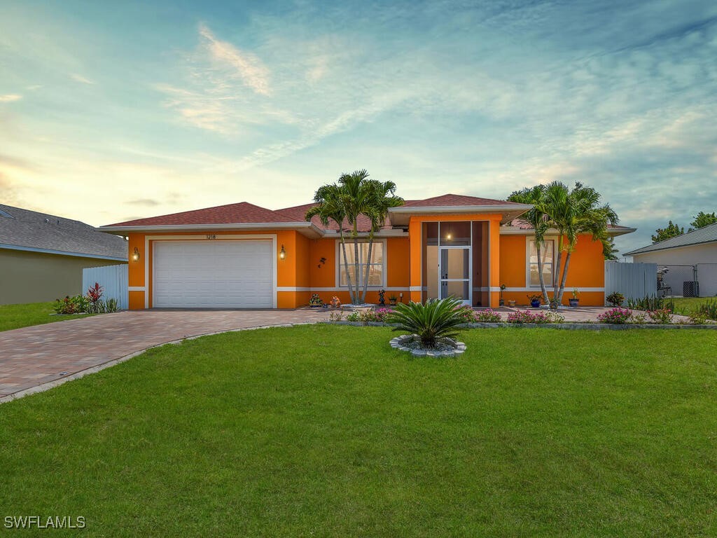 a front view of house with yard barbeque and outdoor seating