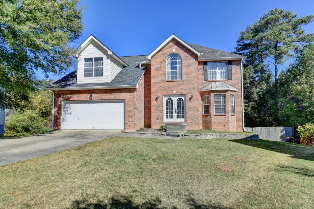 a front view of a house with a yard and garage