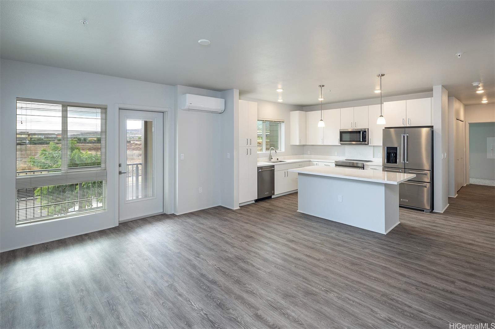 a kitchen with stainless steel appliances a refrigerator sink and microwave