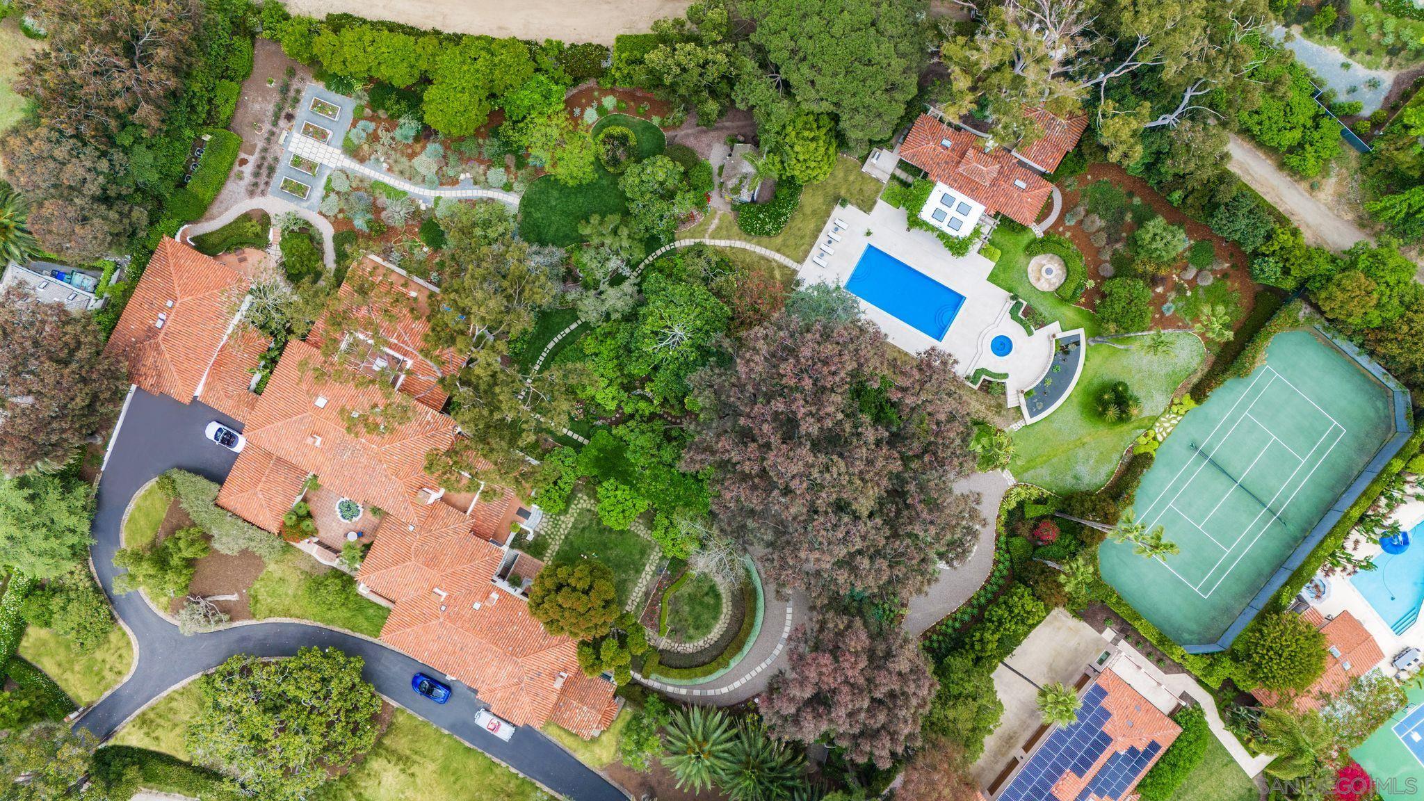 an aerial view of a house with a yard and potted plants