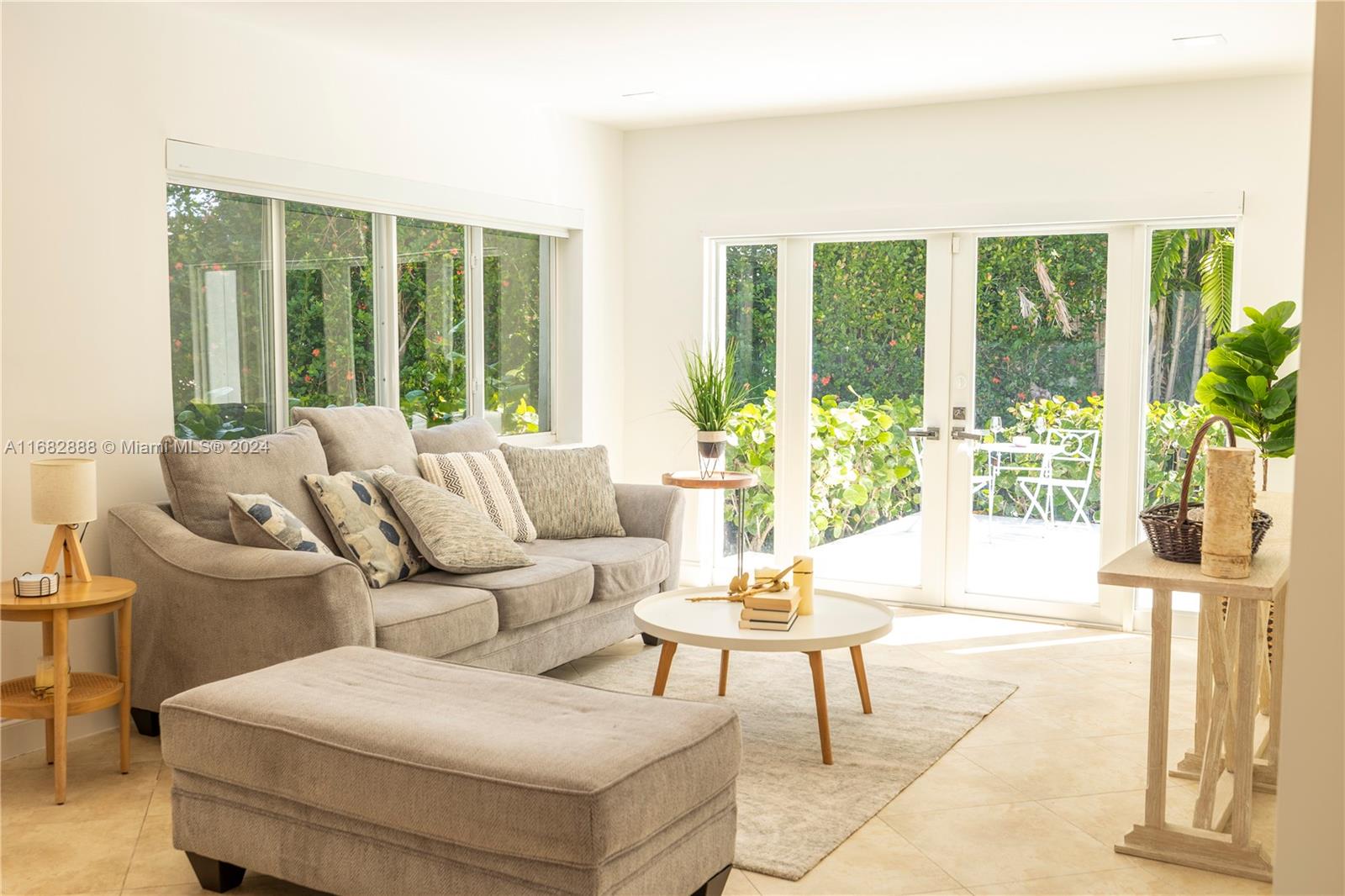 a living room with furniture and a potted plant