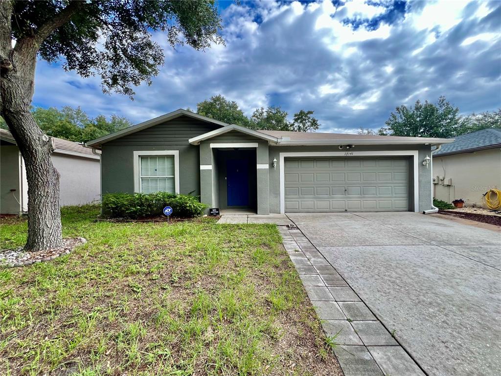 a front view of a house with a yard and garage