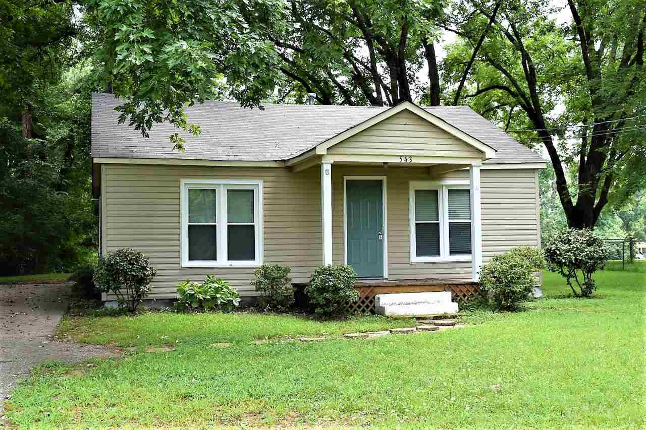 a front view of a house with a yard and porch