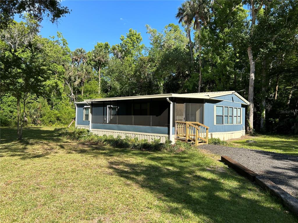 a house that has a big yard with large trees