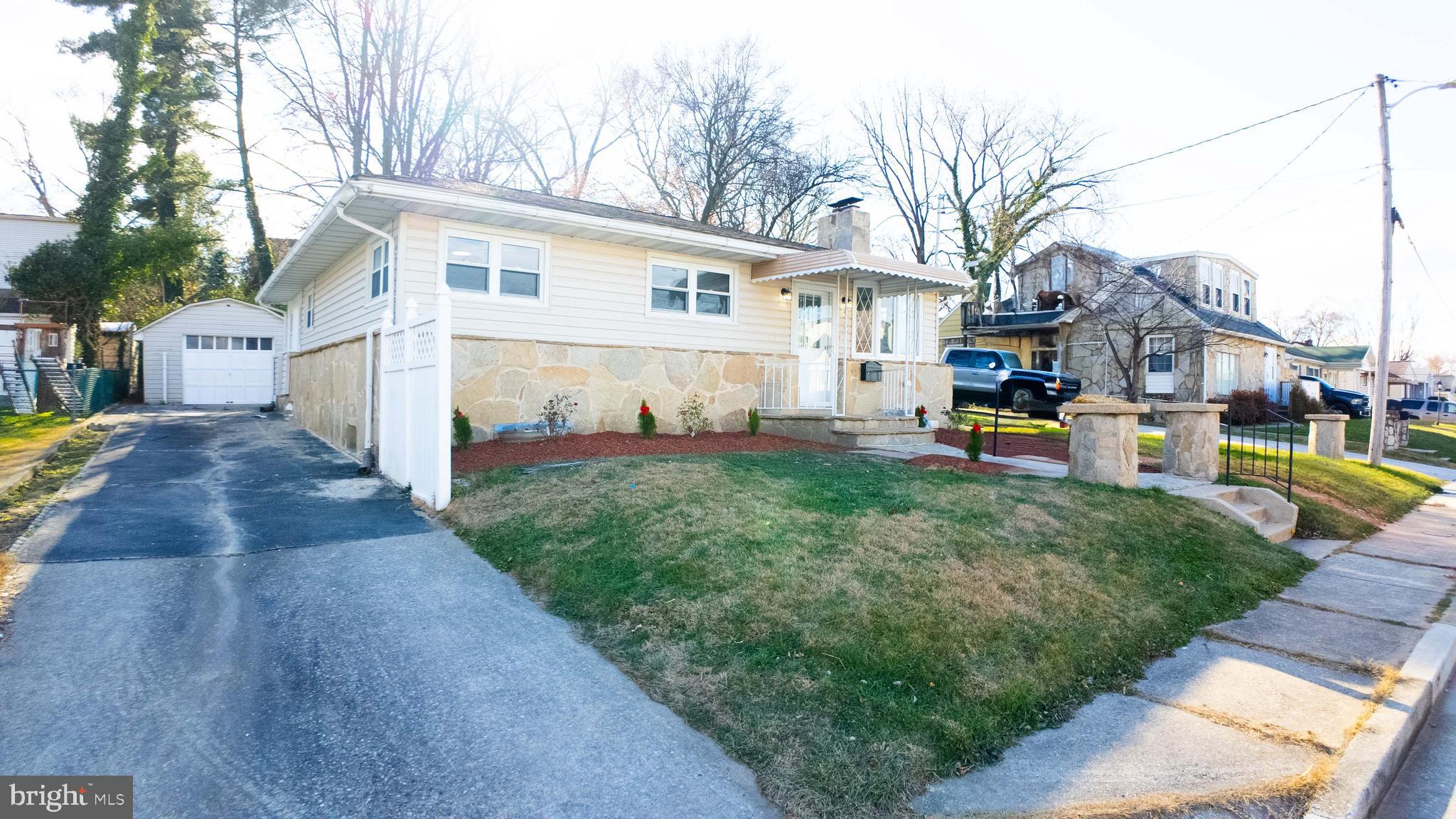 a view of a house with backyard and a tree