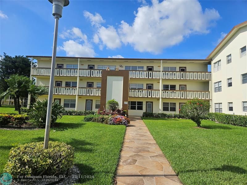 a front view of a building with garden