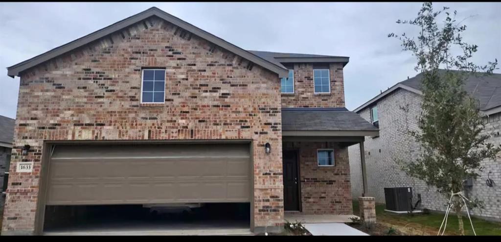 a front view of a house with garage