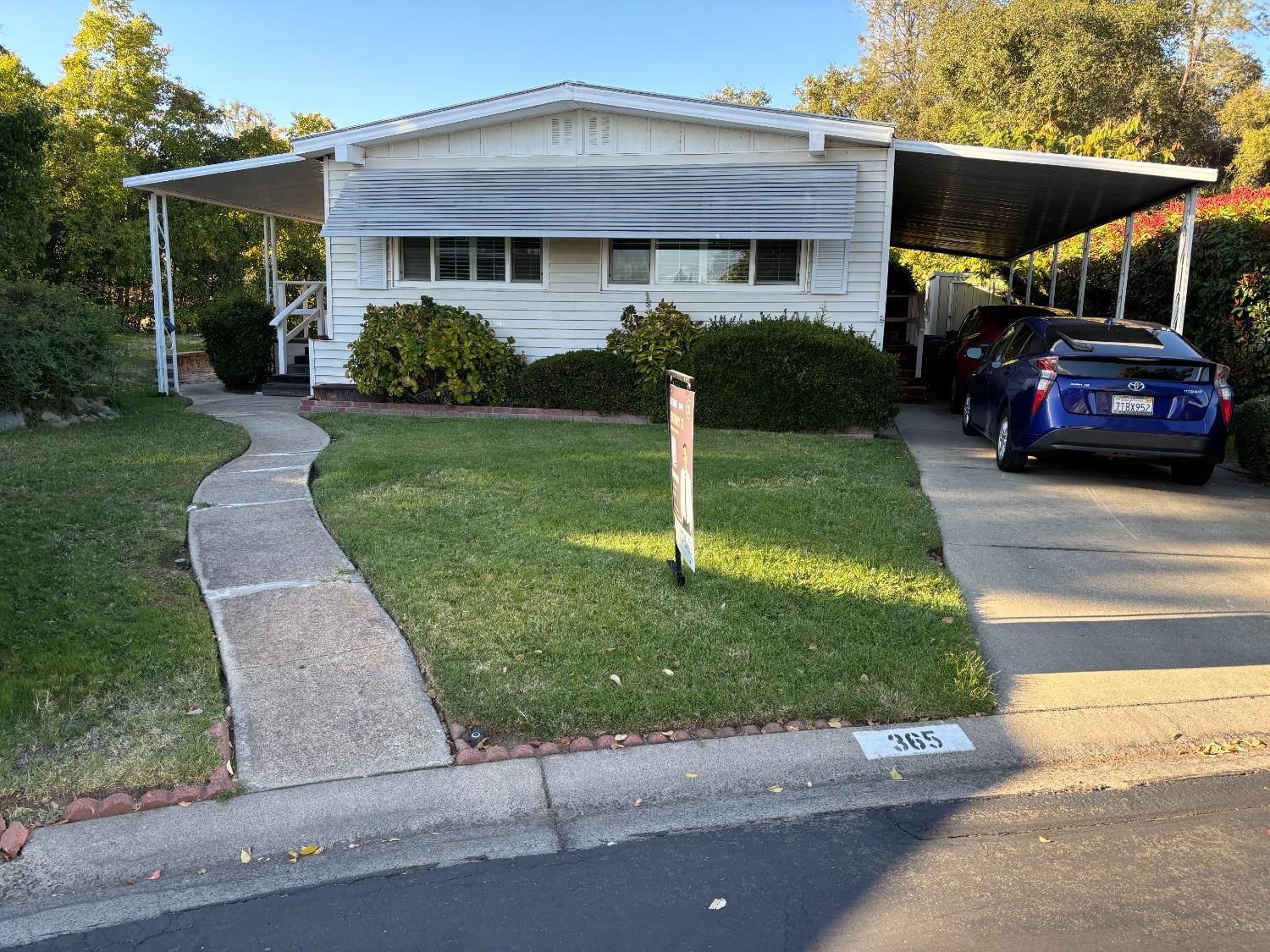 a front view of a house with a garden and plants