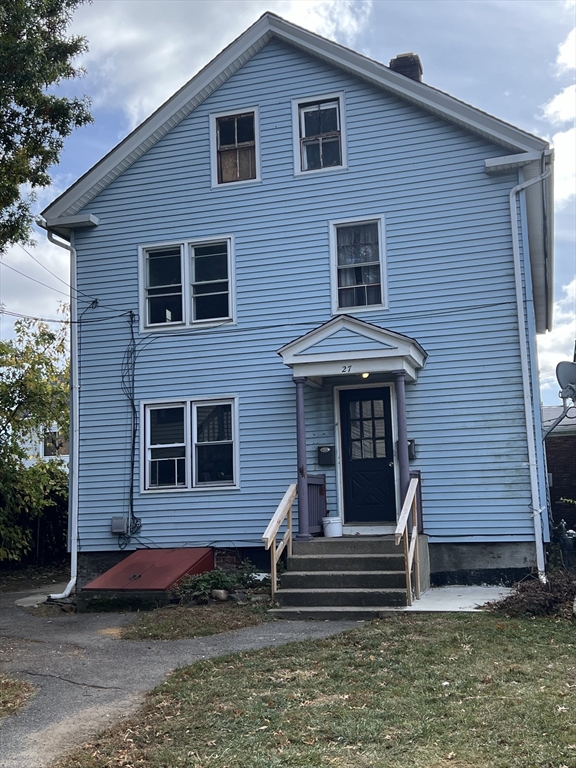 a front view of a house with a garden