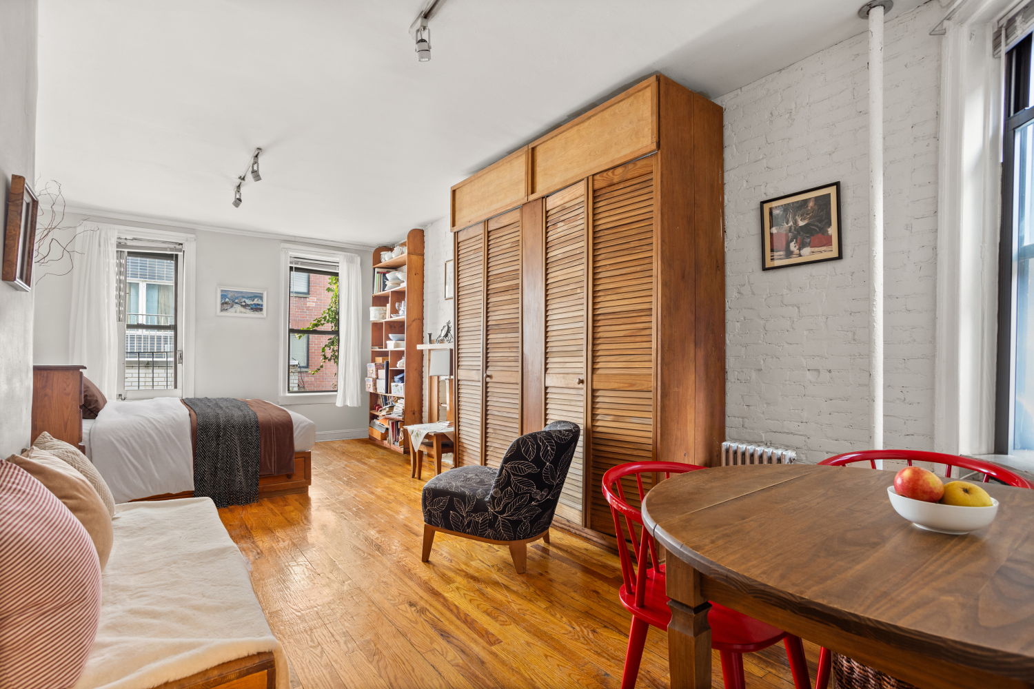 a living room with furniture and large windows